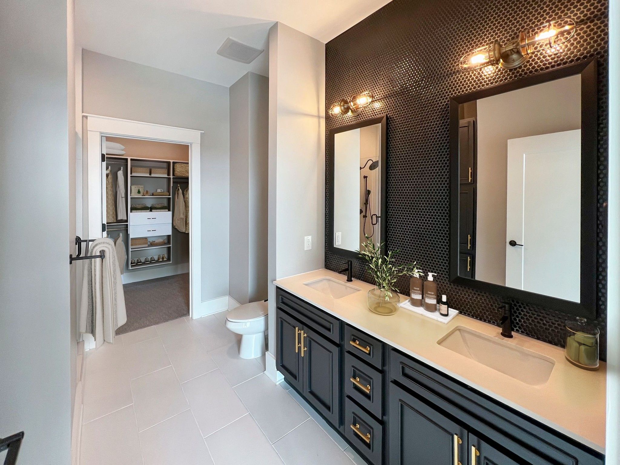 Van Alen apartments in Downtown Durham NC luxury bathroom with custom designer tile and gold fixtures