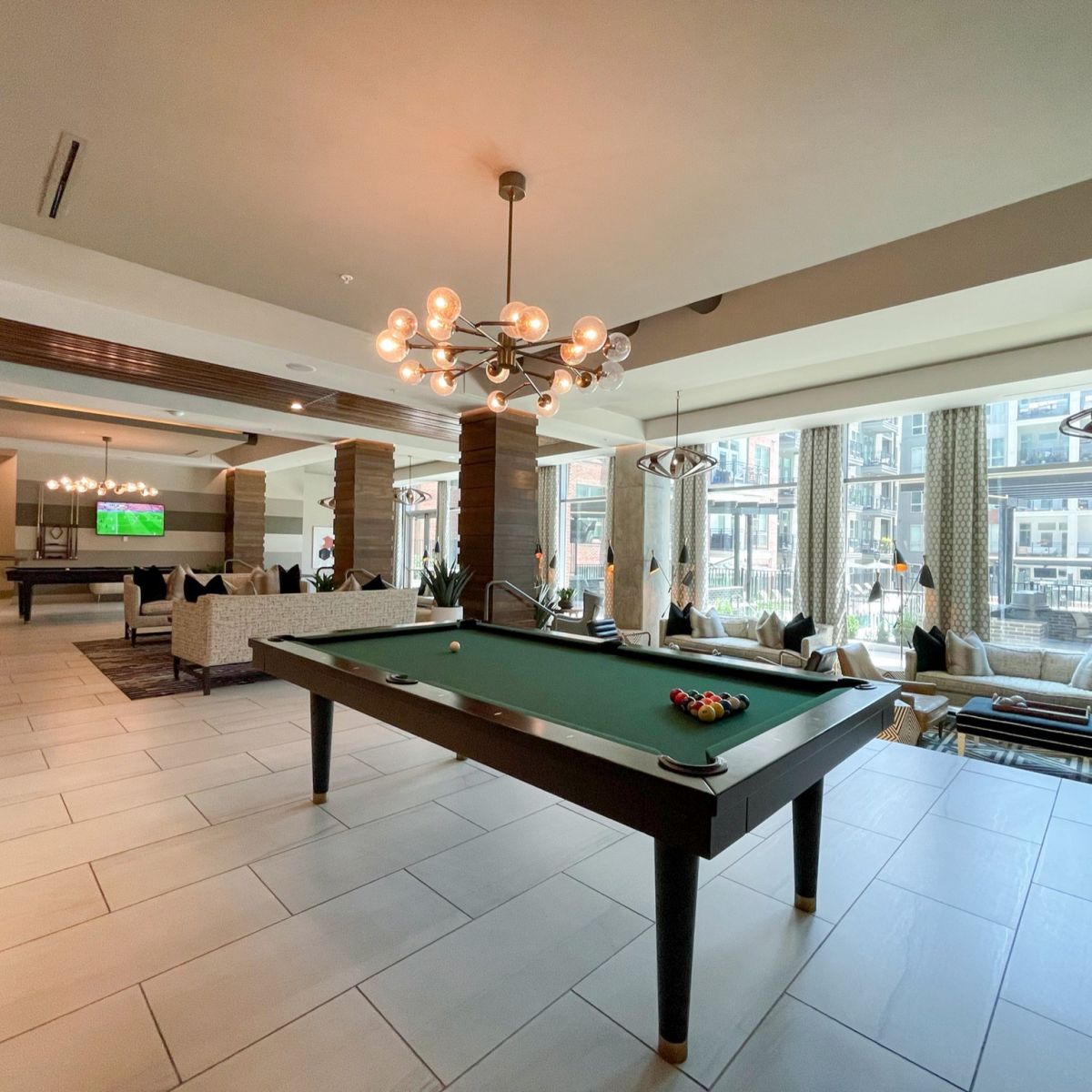 Van Alen apartments resident community lounge with billiards tables and courtyard views