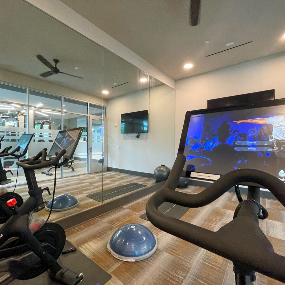 Van Alen apartments resident amenity fitness studio with Peloton bikes and yoga space